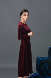 Velvet long-sleeve midi dress with pearl button detailing and tailored waist silhouette
